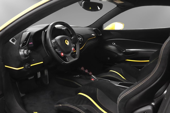 Cockpit of the Ferrari 488 Pista: black Alcantara interior with yellow accent stitching and carbon racing seats