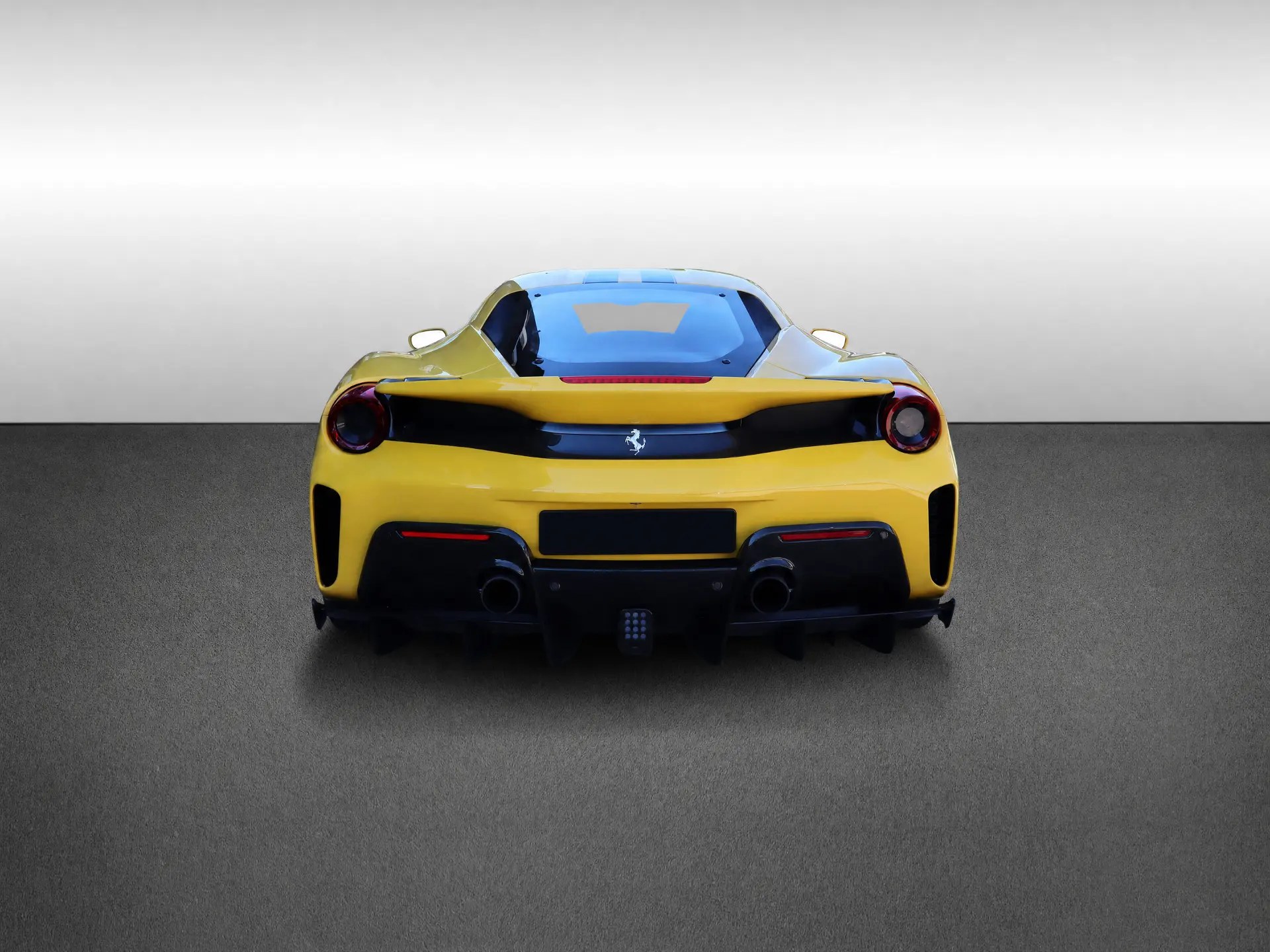 Ferrari 488 Pista in Giallo Modena, rear view showing the aerodynamic diffuser and twin exhausts