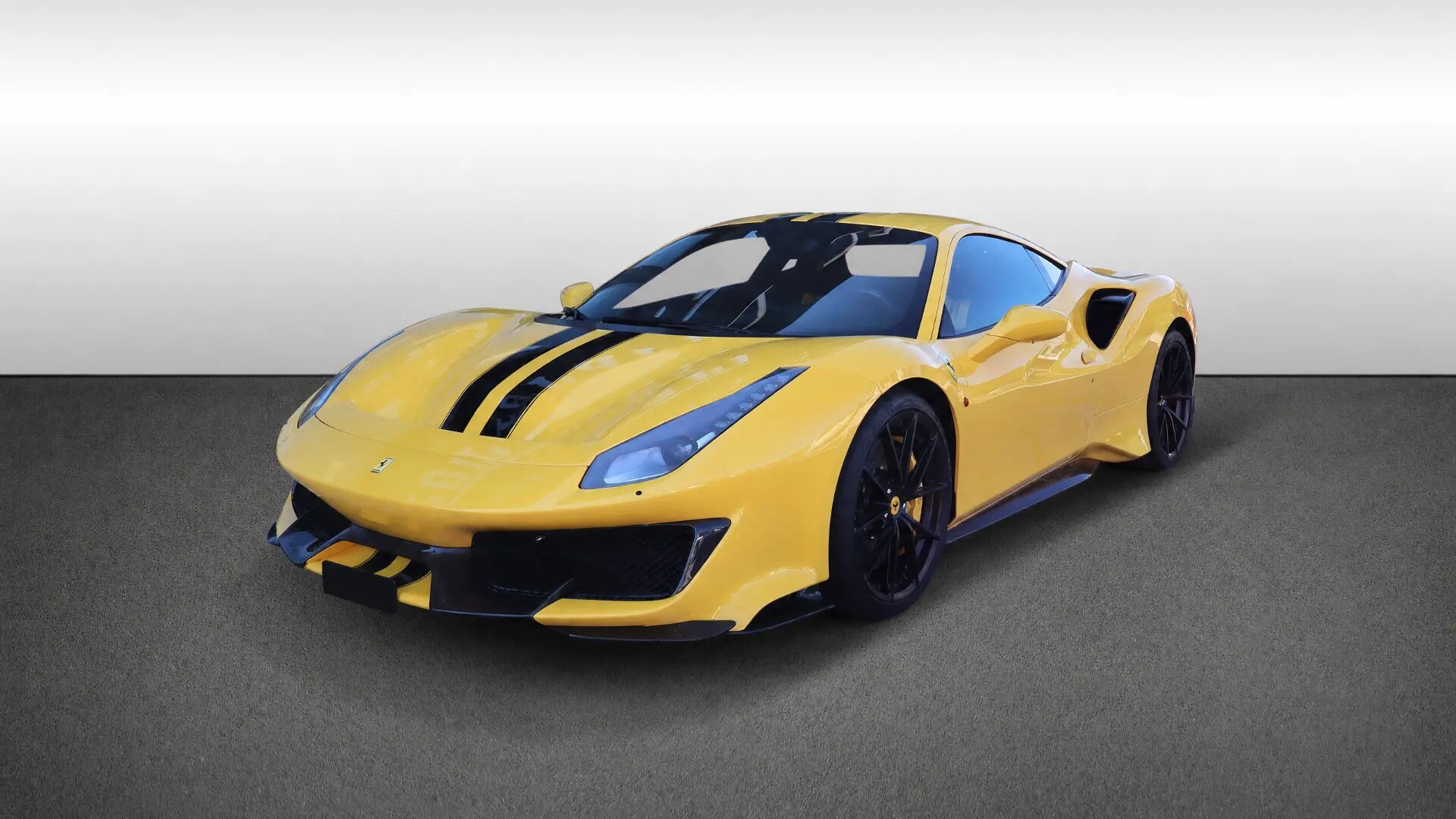 Side profile of the Ferrari 488 Pista in Giallo Modena, showing its Le Mans stripe and aerodynamic flanks